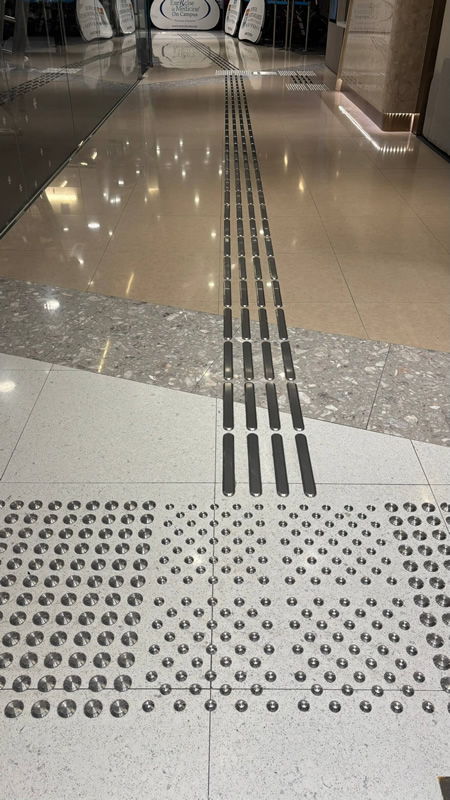 Interior view of a sports facility with wide circulation space suitable for wheelchair users