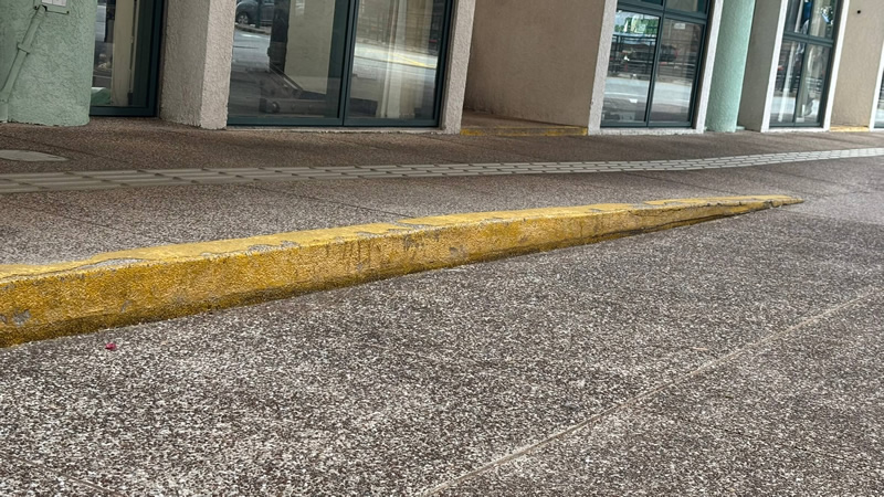 Tactile guide path with raised surface guiding users to a fitness centre entrance